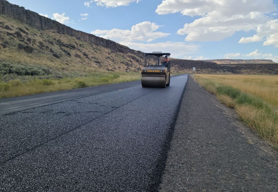 Double drum roller compacting a new asphalt mat while it is still hot
